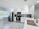 Modern kitchen with stainless steel appliances, quartz countertops, updated white cabinetry and sink area at 19029 Us Highway 19 N # 27A, Clearwater, FL 33764