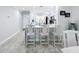 Bright kitchen with a breakfast bar, modern sink, and stainless steel appliances at 19029 Us Highway 19 N # 27A, Clearwater, FL 33764