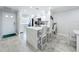 Kitchen island featuring stainless steel appliances, white cabinetry, quartz countertops, and open floor plan at 19029 Us Highway 19 N # 27A, Clearwater, FL 33764