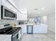 Spacious kitchen with stainless appliances, white cabinets and countertops, and open floor plan at 19029 Us Highway 19 N # 27A, Clearwater, FL 33764