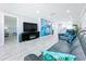 Open concept living space with modern entertainment center and colorful wall art at 19029 Us Highway 19 N # 27A, Clearwater, FL 33764