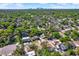 Expansive aerial view of a neighborhood with lush green trees, showcasing proximity to the city skyline at 1908 E Mcberry St, Tampa, FL 33610