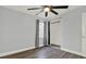 Bedroom featuring hardwood floors, a ceiling fan, window, and a closet at 1908 E Mcberry St, Tampa, FL 33610