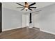 Spacious bedroom with hardwood floors, large ceiling fan, and closet at 1908 E Mcberry St, Tampa, FL 33610