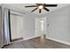 Bedroom features hardwood floors, a ceiling fan, closet, and natural light at 1908 E Mcberry St, Tampa, FL 33610