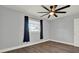 Bright bedroom features hardwood floors, a ceiling fan, and a window with natural light at 1908 E Mcberry St, Tampa, FL 33610