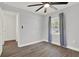 Bright bedroom with hardwood floors, a ceiling fan, and natural light from the window at 1908 E Mcberry St, Tampa, FL 33610
