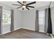 Cozy bedroom with hardwood floors, two windows, and lots of natural light at 1908 E Mcberry St, Tampa, FL 33610