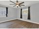 Bedroom with gray walls, new laminate flooring and two windows letting in natural light at 1908 E Mcberry St, Tampa, FL 33610