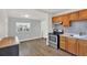 Kitchen with wood cabinets, stainless steel appliances, and mosaic tile backsplash at 1908 E Mcberry St, Tampa, FL 33610