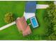 An aerial view shows a backyard oasis, complete with screened pool, and lush landscaping at 20 2Nd Se Ave, Lutz, FL 33549