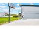 Exterior view of basketball hoop and detached structure with upper level and spiral staircase at 20 2Nd Se Ave, Lutz, FL 33549