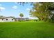 Expansive backyard with a lush green lawn and a view of the pool at 20 2Nd Se Ave, Lutz, FL 33549