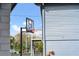 Backyard basketball court with a modern hoop system, spiral staircase, and convenient ball storage on the side of the house at 20 2Nd Se Ave, Lutz, FL 33549