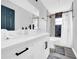 Bathroom features white cabinetry, modern fixtures, and a shower over tub at 20 2Nd Se Ave, Lutz, FL 33549