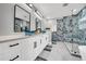 Beautiful main bathroom features dual vanities, quartz countertops, and stylish glass shower at 20 2Nd Se Ave, Lutz, FL 33549