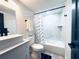 Bathroom with shower-tub combo, nautical curtain, and quartz countertop at 20 2Nd Se Ave, Lutz, FL 33549