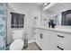 Bright bathroom featuring white vanity with black fixtures and a mirror at 20 2Nd Se Ave, Lutz, FL 33549