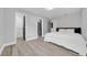 Bright bedroom features wood-look flooring, neutral walls, and a queen-sized bed with a dark wood headboard at 20 2Nd Se Ave, Lutz, FL 33549