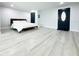 Bedroom features light-colored vinyl flooring, freshly painted walls, and a minimalist aesthetic at 20 2Nd Se Ave, Lutz, FL 33549