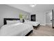 Bright bedroom with a large window and two beds, each with white linens and dark headboards at 20 2Nd Se Ave, Lutz, FL 33549