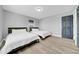 Bedroom with two beds and luxury vinyl flooring. Features natural light and neutral decor at 20 2Nd Se Ave, Lutz, FL 33549