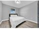 Bedroom featuring luxury vinyl plank flooring, neutral walls, and a bright window at 20 2Nd Se Ave, Lutz, FL 33549