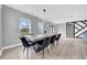 Elegant dining room with modern chandelier, large table, and ample natural light from windows at 20 2Nd Se Ave, Lutz, FL 33549