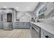 Beautiful kitchen with gray cabinets, quartz countertops, stainless steel appliances, and stylish backsplash at 20 2Nd Se Ave, Lutz, FL 33549
