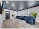 Inviting living room with comfortable blue sofa, wood look flooring, and natural lighting at 20 2Nd Se Ave, Lutz, FL 33549