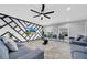 Modern living room with stylish decor, ceiling fan, large windows, and comfortable seating at 20 2Nd Se Ave, Lutz, FL 33549