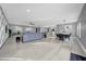 Bright, open-concept living space with hardwood floors, modern furniture, and dining and kitchen area at 20 2Nd Se Ave, Lutz, FL 33549
