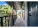 Covered porch with tropical plants and a modern front door at 20 2Nd Se Ave, Lutz, FL 33549