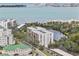 Panoramic aerial view of waterfront condo community, showcasing the building and surrounding natural beauty at 220 Belleview Blvd # 701, Belleair, FL 33756