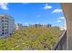 A pleasant balcony view overlooks the lush mature trees and neighborhood condo buildings, offering a relaxing scene at 220 Belleview Blvd # 701, Belleair, FL 33756