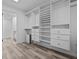 Spacious walk-in closet with custom shelving and wood-look flooring at 220 Belleview Blvd # 701, Belleair, FL 33756