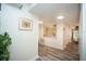 Bright hallway with wood-look flooring, artwork, and access to rooms at 220 Belleview Blvd # 701, Belleair, FL 33756