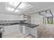 Spacious kitchen with stainless steel appliances, gray countertops, and open access to the living area at 220 Belleview Blvd # 701, Belleair, FL 33756