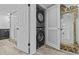Convenient laundry area featuring a stacked washer and dryer at 220 Belleview Blvd # 701, Belleair, FL 33756