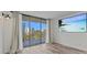 Living room featuring sliding glass doors, a television, and neutral walls at 220 Belleview Blvd # 701, Belleair, FL 33756