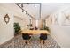 Open floor plan featuring modern track lighting, stylish furniture, plants, a dining table, and a cozy living area at 220 Belleview Blvd # 701, Belleair, FL 33756