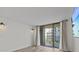 Bright living room featuring sliding glass doors and wood-look flooring at 220 Belleview Blvd # 701, Belleair, FL 33756