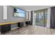 Living room showcasing a large desk and sliding glass doors to a balcony at 220 Belleview Blvd # 701, Belleair, FL 33756