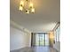 Bright living room featuring a modern light fixture, large windows, and hardwood flooring at 220 Belleview Blvd # 701, Belleair, FL 33756