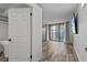 Bright living room featuring sliding glass doors and wood-look flooring at 220 Belleview Blvd # 701, Belleair, FL 33756