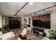A cozy living room with modern track lighting, stylish furniture, and a stunning sunset view from the window at 220 Belleview Blvd # 701, Belleair, FL 33756