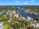 Expansive aerial view of waterfront property with lush landscaping and bay views in a desirable neighborhood at 292 Sunlit Cove Ne Dr, St Petersburg, FL 33702