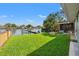 Inviting back yard with manicured lawn, waterfront views, dock and fire pit at 292 Sunlit Cove Ne Dr, St Petersburg, FL 33702