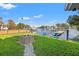 Beautiful backyard with lush lawn, a fire pit, and a private dock on the serene waterfront at 292 Sunlit Cove Ne Dr, St Petersburg, FL 33702