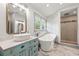 Bright bathroom featuring a soaking tub, walk-in shower, vessel sink, and marble tile floor at 292 Sunlit Cove Ne Dr, St Petersburg, FL 33702